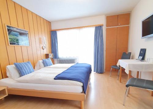 Llit o llits en una habitació de Hotel-Restaurant Grina