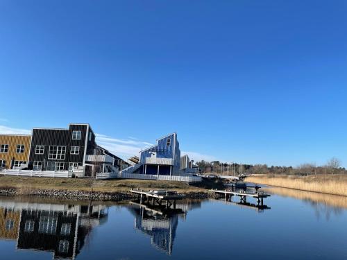 a building next to a body of water at Perle Øer Maritime ferieby Ebeltoft in Ebeltoft