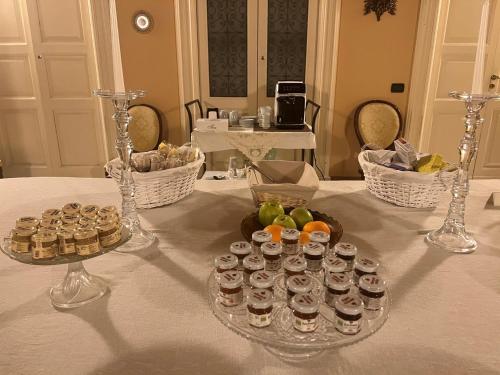 a table with glasses and a plate of food on it at Palazzo Francesco Grassi in Aradeo