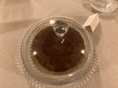 a glass plate with a wine glass on a table at Palazzo Francesco Grassi in Aradeo