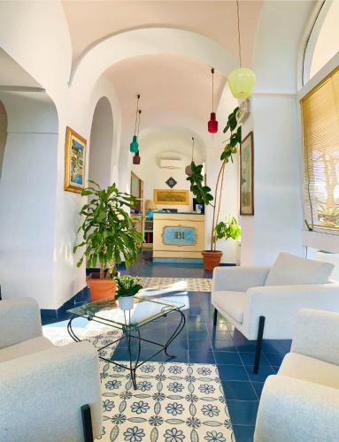 a living room with white couches and a table at Hotel Bellavista in Anacapri