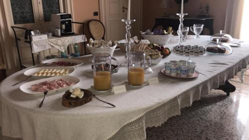 a table with a buffet of food on it at Palazzo Francesco Grassi in Aradeo