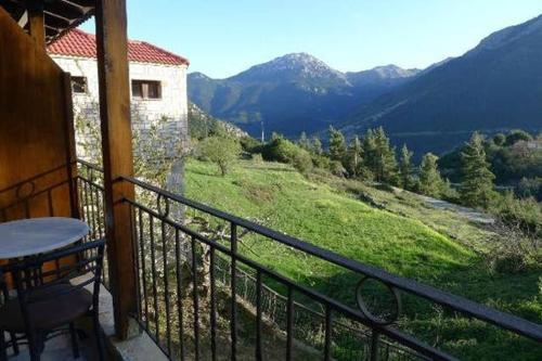 a balcony of a house with a view of a mountain at Guesthouse Kastania Korakis in Kastanéa