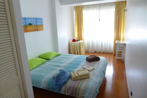 a bedroom with a bed with towels on it at Be Local - Apartment with 2 bedrooms in Infantado in Loures in Loures