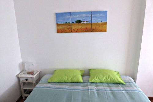 a bedroom with a bed with two green pillows at Be Local - Apartment with 2 bedrooms in Infantado in Loures in Loures