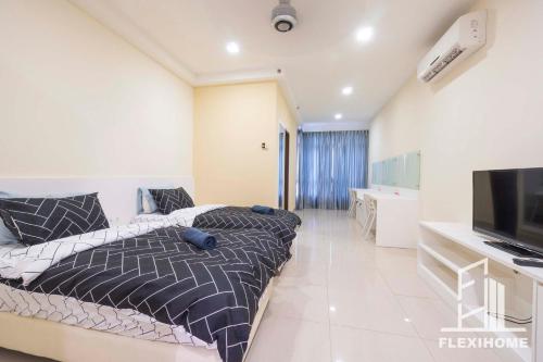 a bedroom with a bed and a flat screen tv at 9am-5pm, SAME DAY CHECK IN AND CHECK OUT, Work From Home, Shaftsbury-Cyberjaya, Comfy Home by Flexihome-MY in Cyberjaya