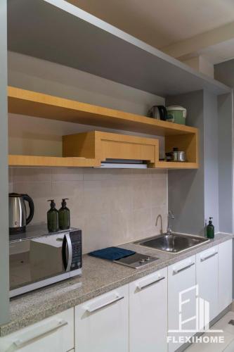 a kitchen with a sink and a microwave at 9am-5pm, SAME DAY CHECK IN AND CHECK OUT, Work From Home, Shaftsbury-Cyberjaya, Comfy Home by Flexihome-MY in Cyberjaya