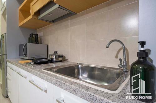 a kitchen with a stainless steel sink and a stove at 9am-5pm, SAME DAY CHECK IN AND CHECK OUT, Work From Home, Shaftsbury-Cyberjaya, Comfy Home by Flexihome-MY in Cyberjaya