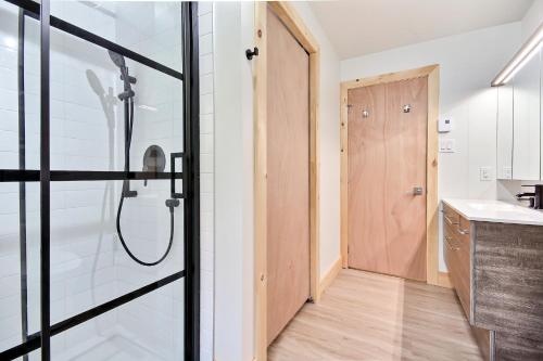 a bathroom with a shower and a sink at Sutton Wellness cabin #267 Rez-de-chaussée in Sutton