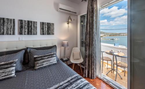 a bedroom with a bed and a view of the ocean at Milos Inn in Adamantas