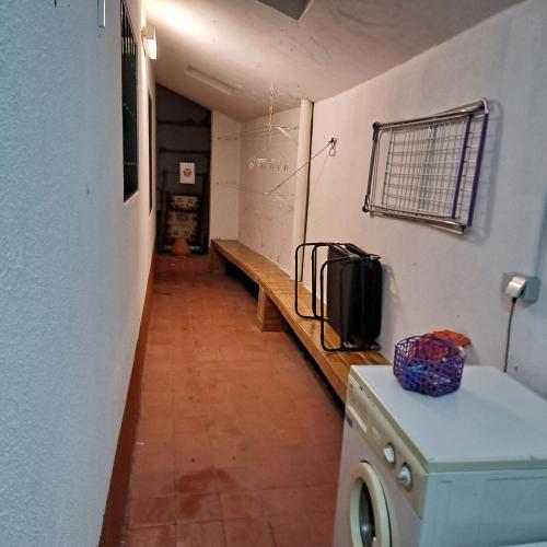 a hallway of a room with a washer at Chalé Seixal - Sea View in Seixal