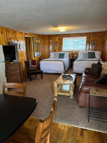 a bedroom with two beds and a living room with a couch at Mountain View Lodge in Red River