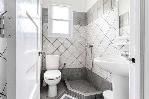 a white bathroom with a toilet and a sink at Despina Studios 4 beds with loft and kitchenette # 8 in Raches