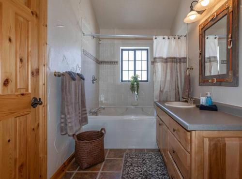 a bathroom with a tub and a sink and a bath tub at MAJESTIC VIEWS FAMILY LODGE with Large Deck in Thayne