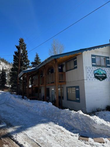 a log home in the snow on a mountain at Mountain View Lodge in Red River