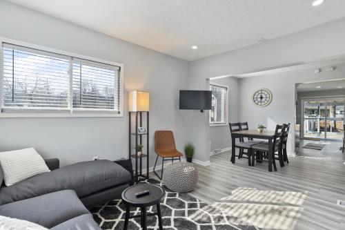 a living room with a couch and a table at Entire Home Near MSU and Local Hospitals with Fast Wi-Fi & Dedicated Office in Lansing