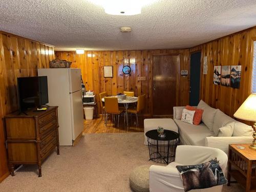 a living room with a couch and a refrigerator at Mountain View Lodge in Red River