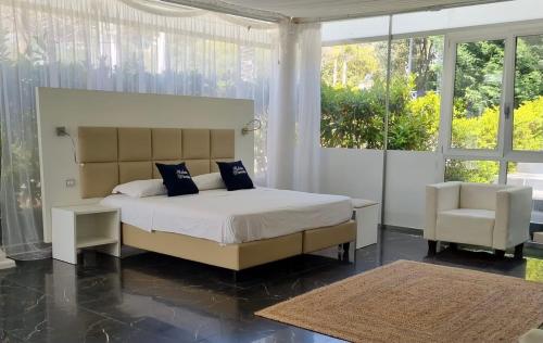 a bedroom with a large bed and a chair at B&B Laura in Terzigno