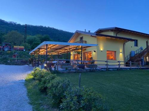 a large house with a roof with a grass yard at Agriturismo La Soglia Del Parco in Ranica