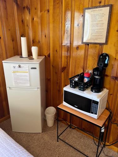 a microwave sitting on a table next to a refrigerator at Mountain View Lodge in Red River