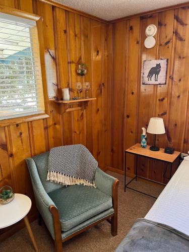 a room with a chair and a table with a lamp at Mountain View Lodge in Red River