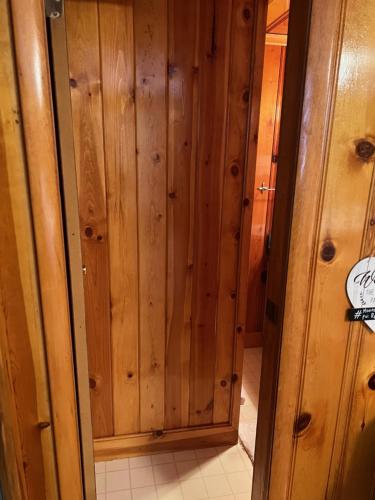 a wooden closet with a door in a room at Mountain View Lodge in Red River