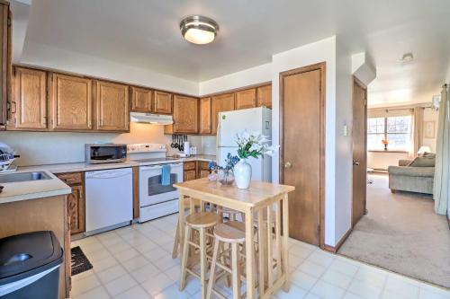 a kitchen with white appliances and a table with stools at Cozy Allentown Home, 2 Mi to Hamilton District! in Allentown