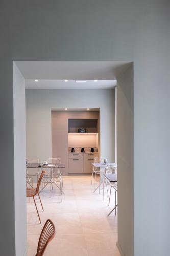 a dining room with chairs and tables in a building at Dome in Catania