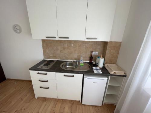 a small kitchen with a sink and a counter at VIP Apartments & Room in Rakovica