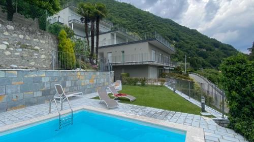 een huis met een zwembad naast een gebouw bij Casa Mille Luci in Argegno