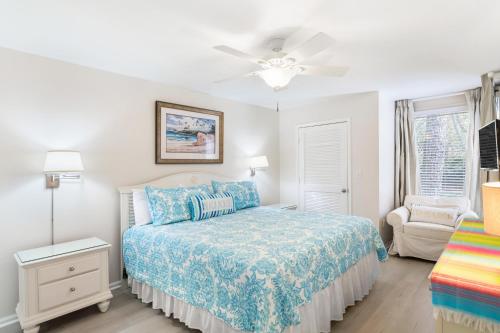 Un dormitorio con una cama y un ventilador de techo. en 1315 Pelican Watch - Seabrook Island - Beachfront 5 Star Condo - Fido Friendly, en Seabrook Island
