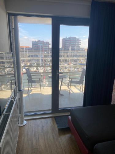 a room with a view of a balcony with chairs at Scheveningen Diamond View Beach and Harbour in Scheveningen