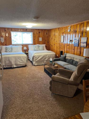 a hotel room with two beds and a couch at Mountain View Lodge in Red River