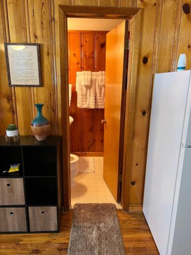a bathroom with a toilet and a refrigerator at Mountain View Lodge in Red River