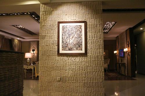 a painting on a brick wall in a lobby at Shelton Rezidor Swat in Swat