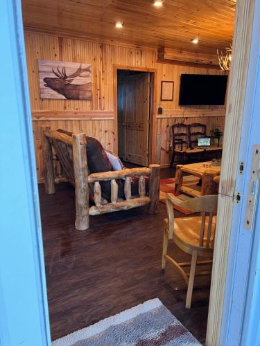 a living room with a couch in a log cabin at Mountain View Lodge in Red River