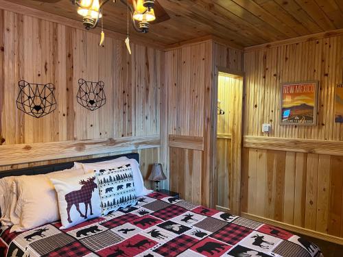 a bedroom with a bed with a deer pillow on it at Mountain View Lodge in Red River