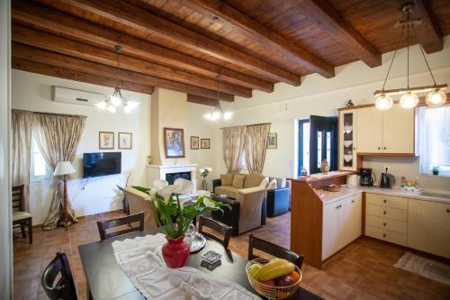a kitchen and a living room with a table and chairs at Aggelina's House by GuestCorfu in Kynopiástai
