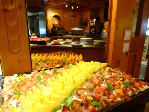 a buffet with many different types of food on display at Hotel Gundolf in Sankt Leonhard im Pitztal