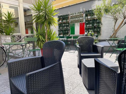 a group of chairs and tables in a restaurant at Lion University & Youth Hostel Milano in Milan