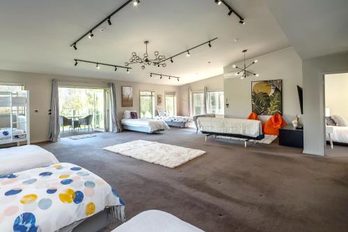 a bedroom with two beds and a living room at Paradise on Campbell in Martinborough