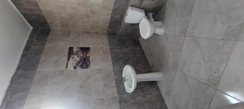 a picture of a bathroom with a magazine on the floor at فيلا بسين خاص in Dawwār Abū Maḩrūs