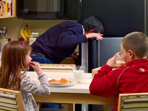 a boy and a girl sitting at a table eating food at Sonesta ES Suites Wilmington - Newark in Newark