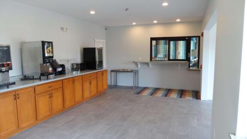 a kitchen with wooden cabinets and a counter top at Motel 6 Houston, TX – Willowbrook Mall in Houston