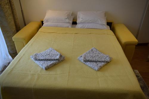 a bed with two pillows on top of it at Belgrade Waterfront Studio Apartment-Supertwins in Sajmište