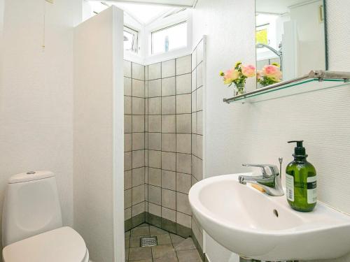 a white bathroom with a sink and a toilet at Holiday home Kerteminde X in Kerteminde