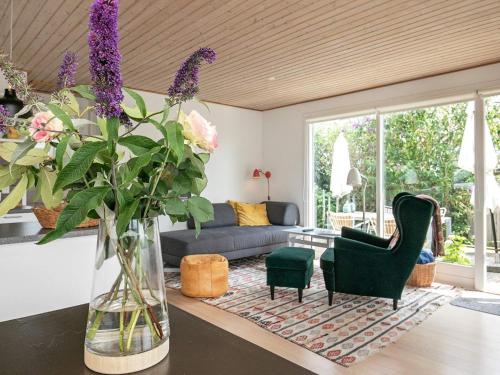 a living room with a vase of flowers on a table at 3 person holiday home in Kerteminde-By Traum in Kerteminde