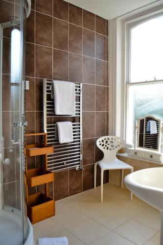 a bathroom with a shower and a sink at Washington House Hotel in Bournemouth