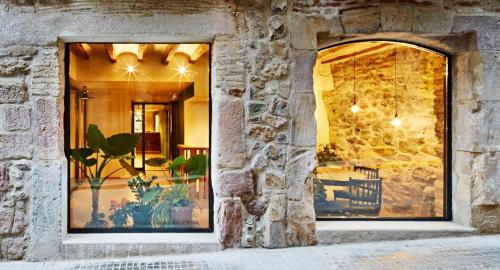 a window of a building with a stone wall at Hotel Restaurant Lotus Priorat in Falset