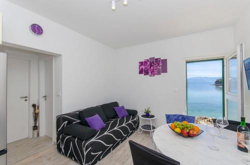 a living room with a couch and a table at Apartment Paradise in Postira